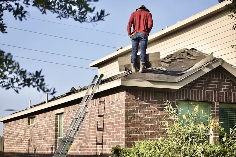 Professional roofer working on a residential roof in Dove Canyon
